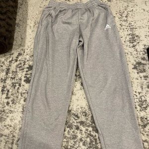 Gray adidas sweatpants with zippers